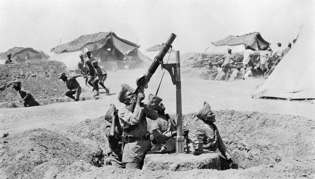 As other soldiers run for the cover of slit trenches, an Indian Lewis gun team engage an enemy aircraft in Mesopotamia, circa 1918