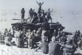 Indian soldiers doing Bhangara atop a captured Pakistani tank in Longewala.