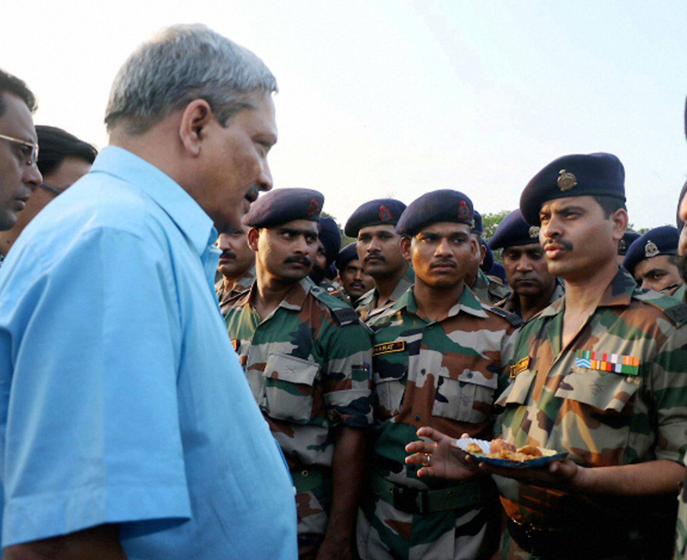 Defence Minister Manohar Parrikar interacting with troops over a cup of tea at Solmara Military Station in Tezpur on Friday. PTI Photo (PTI5_1_2015_000171B)