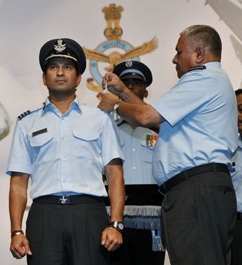 P V Naik, chief of the Indian Air Force, presents the honorary rank of Group Captain to cricketer Sachin Tendulkar during a ceremony in New Delhi