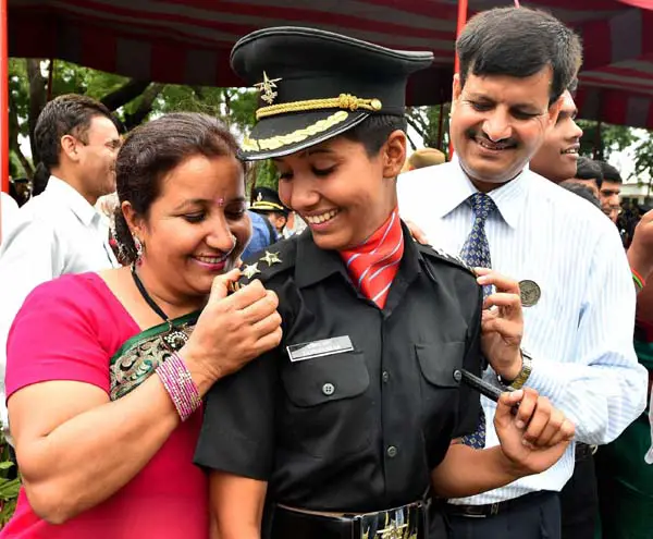 Chennai: A cadet with her parents after a passing out parade at Officers Training Academy in Chennai on Saturday. PTI Photo (PTI9_13_2014_000073b)