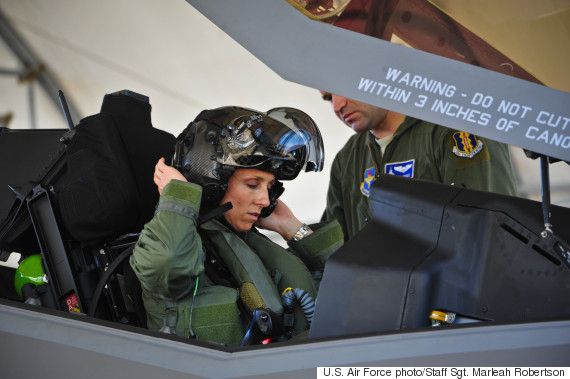 Lt. Col. Christine Mau, 33rd Operations Group deputy commander, puts on her helmet before taking her first flight in the F-35A on Eglin Air Force Base, Fla., May 5, 2015. Mau, who previously flew F-15E Strike Eagles, made history as the first female F-35 pilot in the program. (U.S. Air Force photo/Staff Sgt. Marleah Robertson)