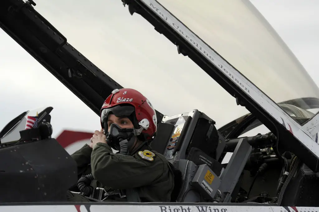 Maj. Caroline Jensen, Thunderbird 3, Right Wing pilot, adjusts her mask before a training sortie at Nellis Air Force Base, Nev., March 12, 2012. (U.S. Air Force photo/Staff Sgt. Larry E. Reid Jr., Released)