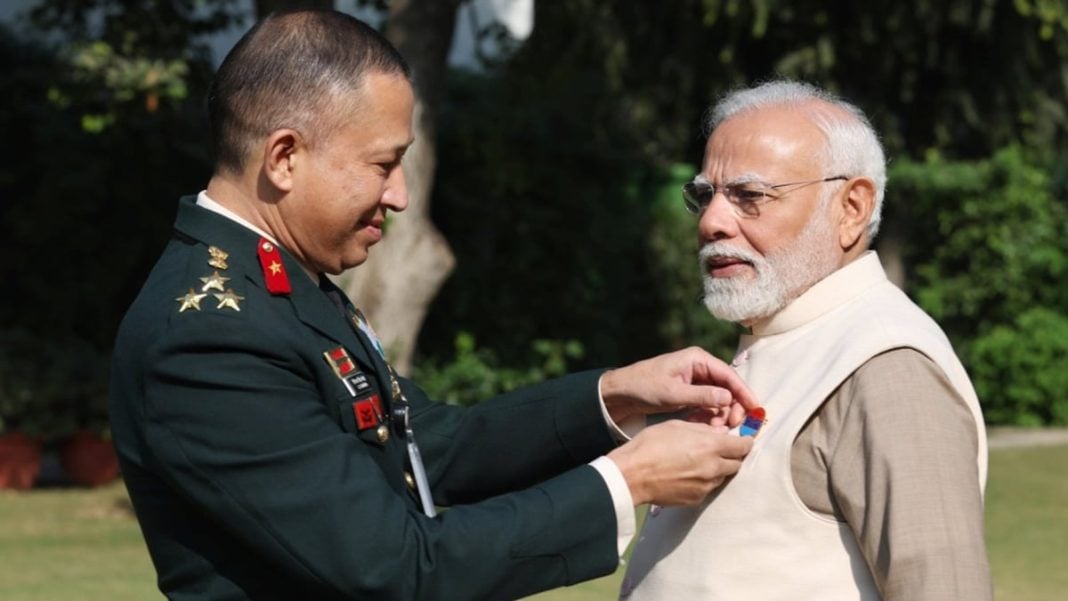 PM Modi Receives Armed Forces Flag Pin, Urges Contributions for Armed Forces Flag Day Fund